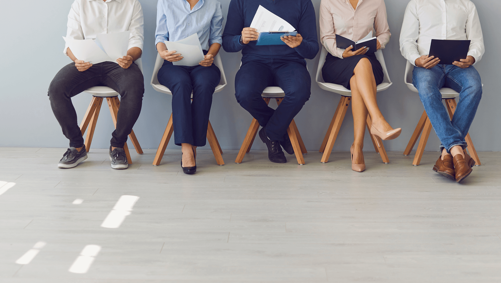 People waiting for a job interview, illustrating common interview red flags NZ employers should watch for